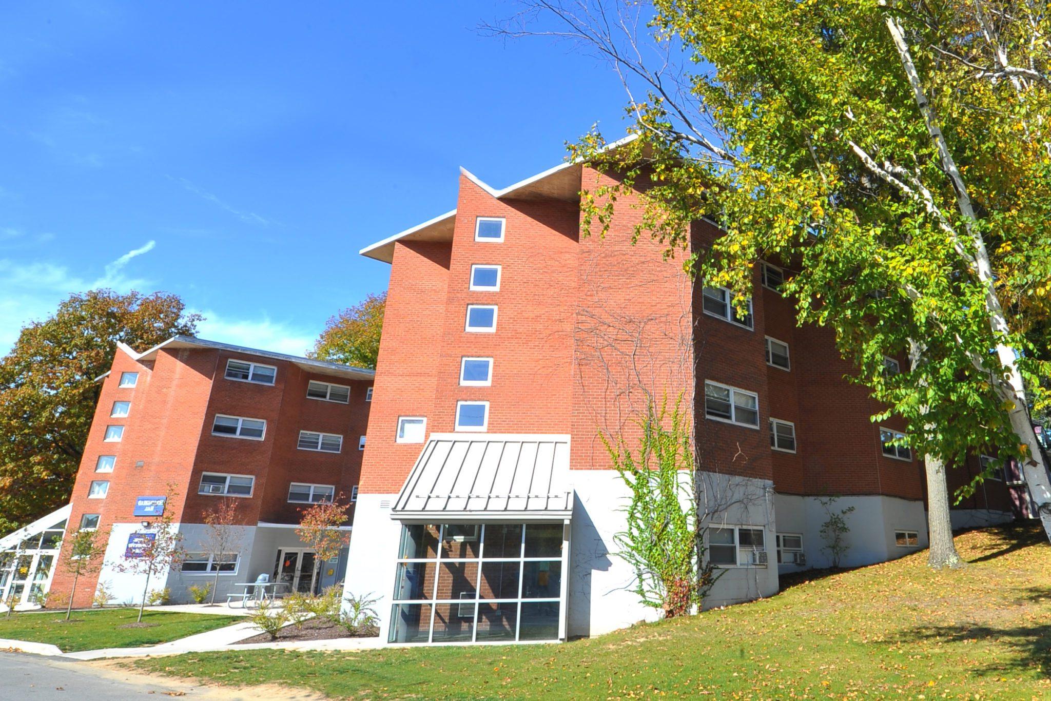 Two brick residence halls with windows and glass entryway at Keystone College